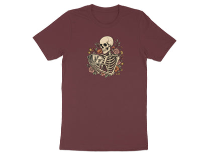 Skeleton holding tarot cards with floral accents on a maroon t-shirt.