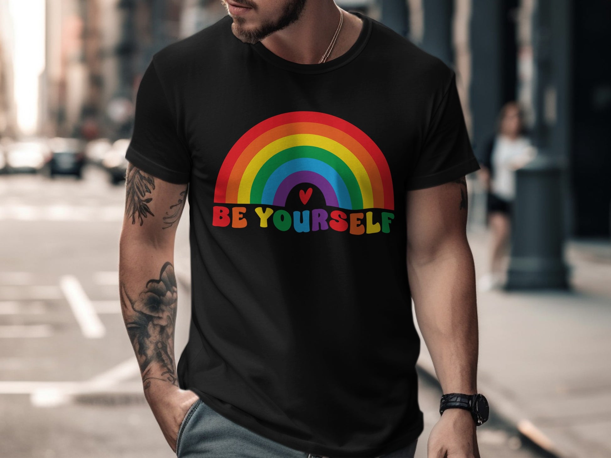 Black t-shirt with colorful rainbow and "Be Yourself" text.