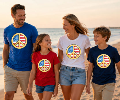 Family in matching shirts with peace sign graphics on a beach.