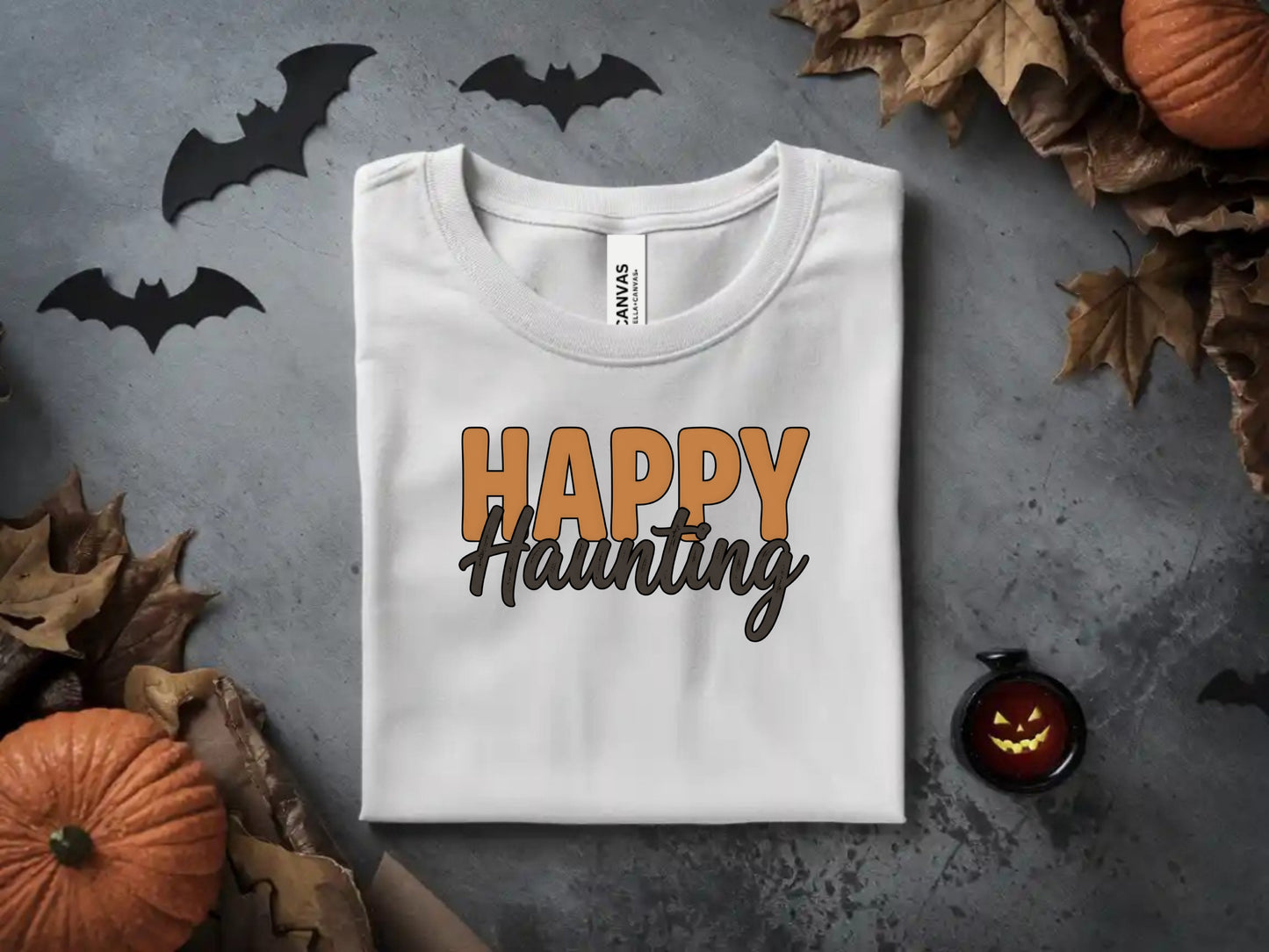 White t-shirt with "Happy Haunting" text and Halloween decor.