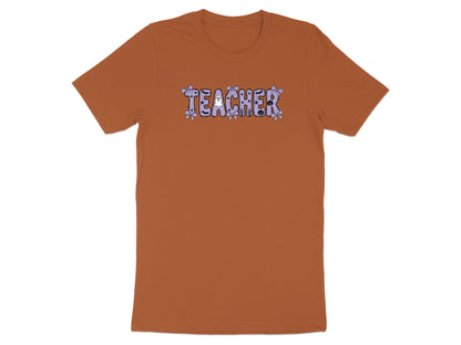 Orange t-shirt with "TEACHER" text in a Halloween-themed font.