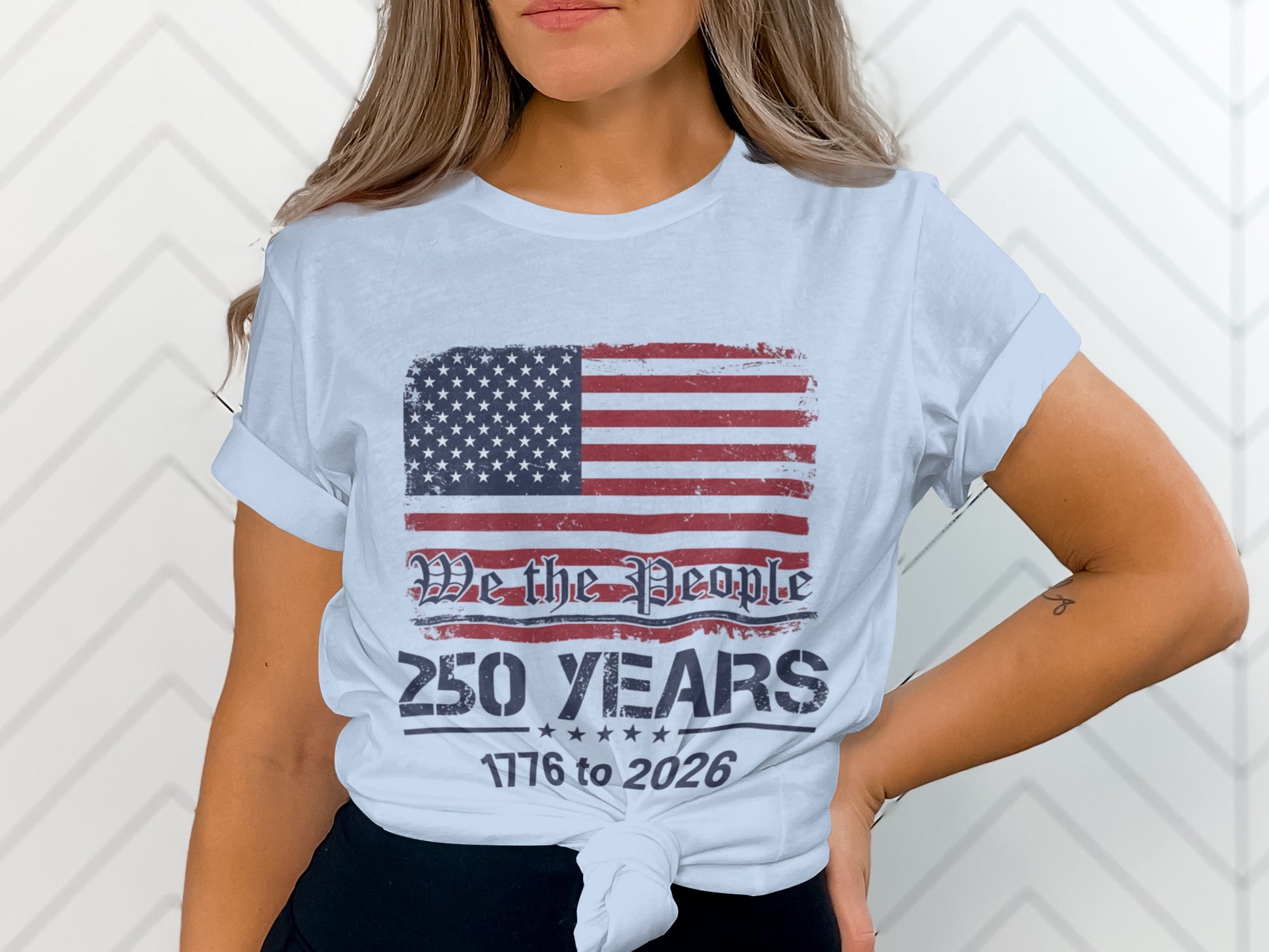 White t-shirt with American flag and text "We the People 250 Years 1776 to 2026".