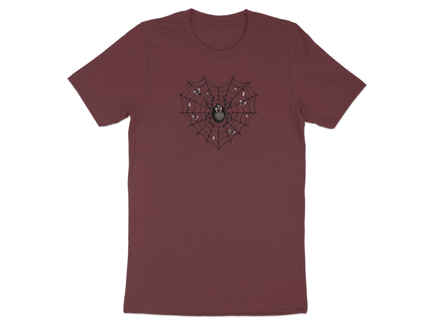 Spider in heart-shaped web with bows and dew drops graphic on maroon t-shirt.