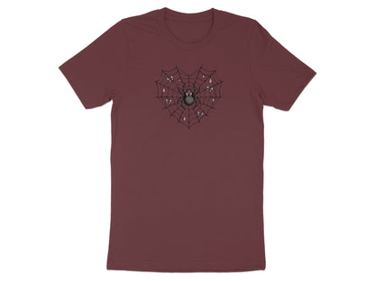 Spider in heart-shaped web with bows and dew drops graphic on maroon t-shirt.