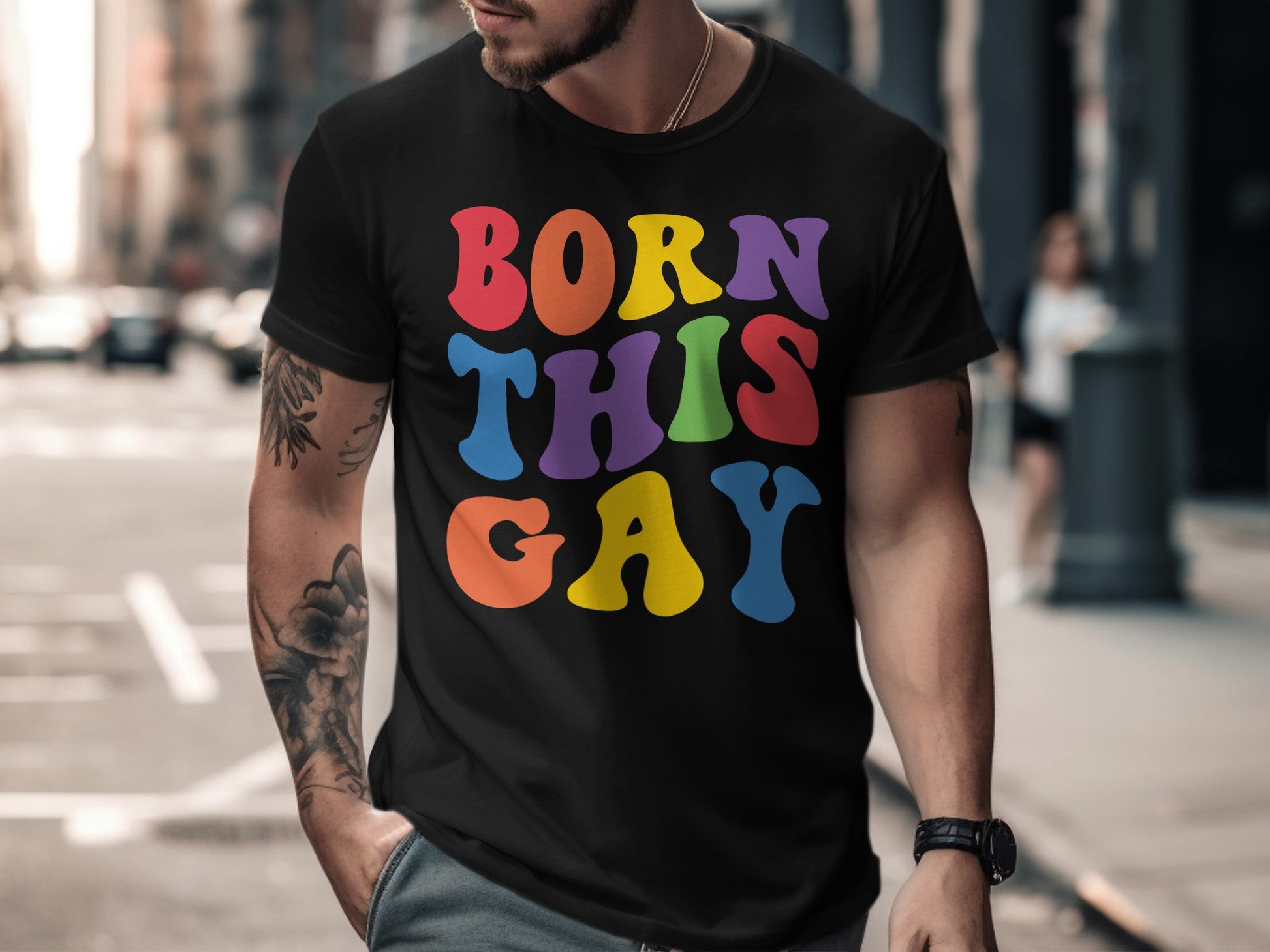 Black t-shirt with "BORN THIS GAY" in colorful rainbow lettering.