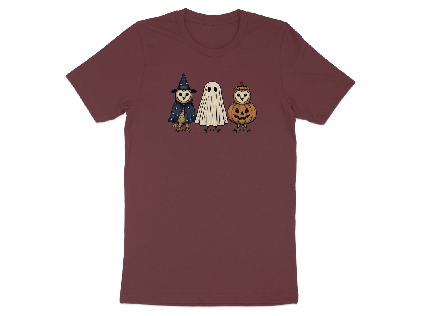 Owls dressed as a witch, ghost, and jack-o'-lantern on a maroon t-shirt.