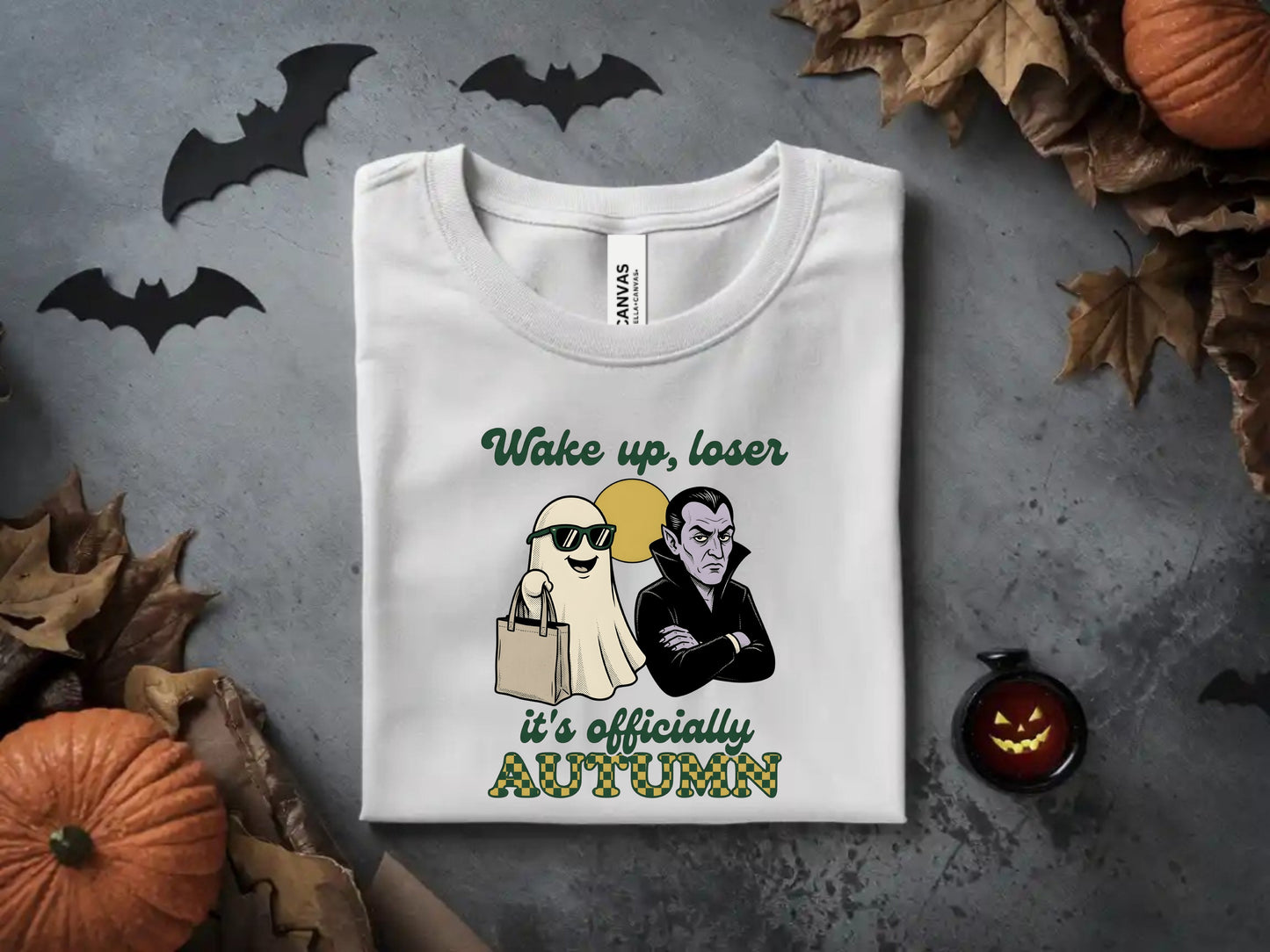 White t-shirt with "Wake up, loser it's officially AUTUMN" and cute ghost and vampire graphics.