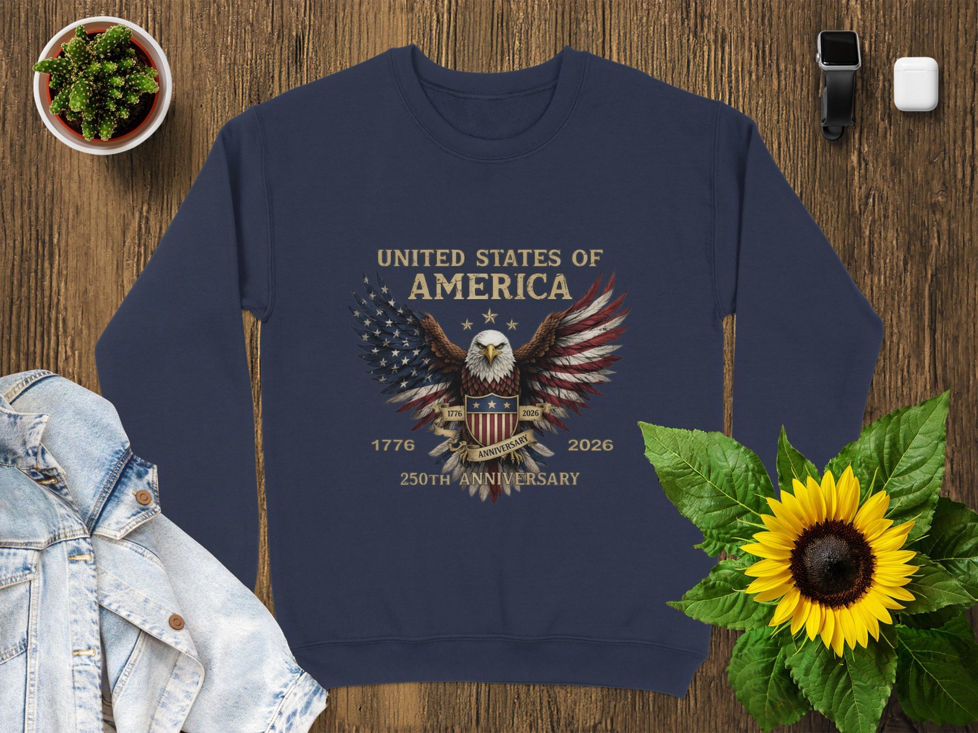 Navy sweatshirt with American flag wings and "United States of America 1776-2026 250th Anniversary" text.