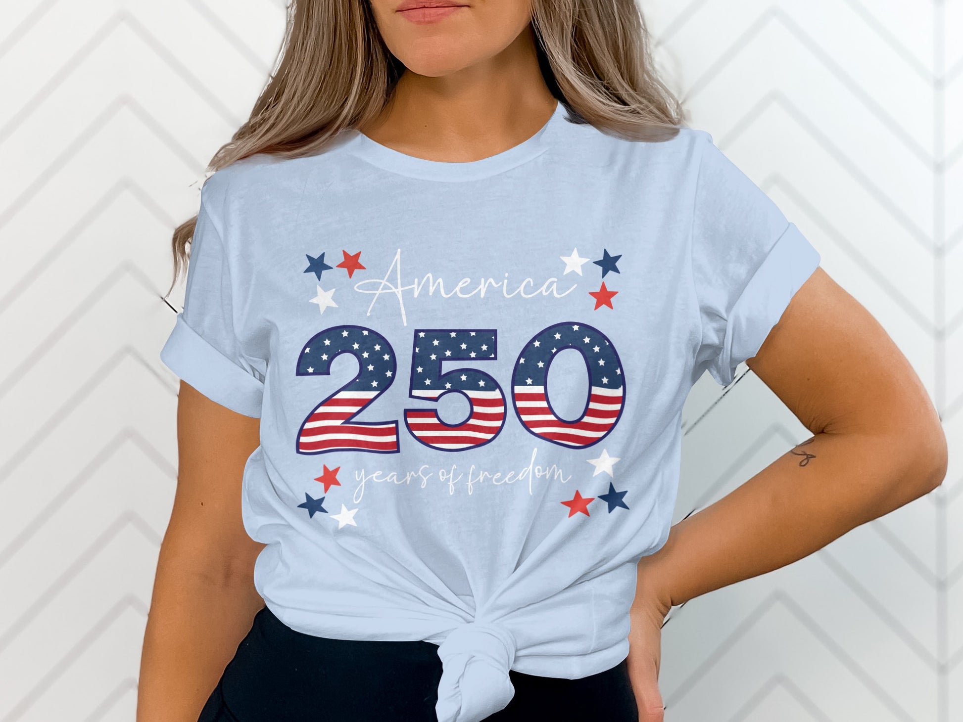 Light blue t-shirt with "America 250 years of freedom" in patriotic design.