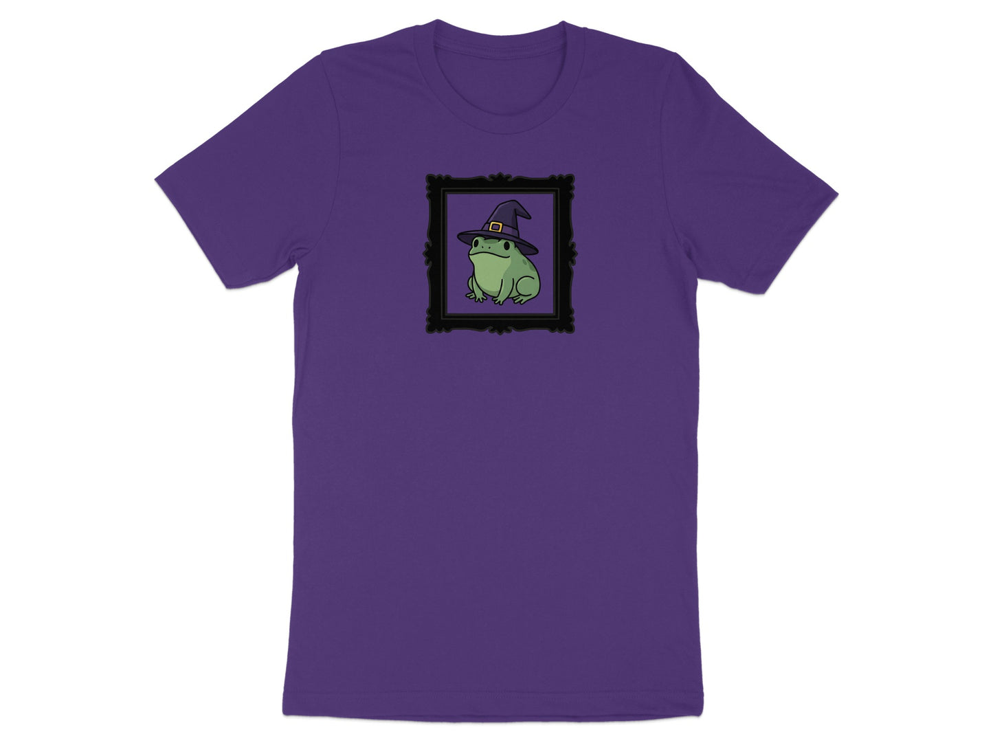 Purple t-shirt with a green frog wearing a witch hat in a black frame.