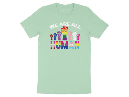 Mint t-shirt with rainbow fists spelling "WE ARE ALL HUMAN".