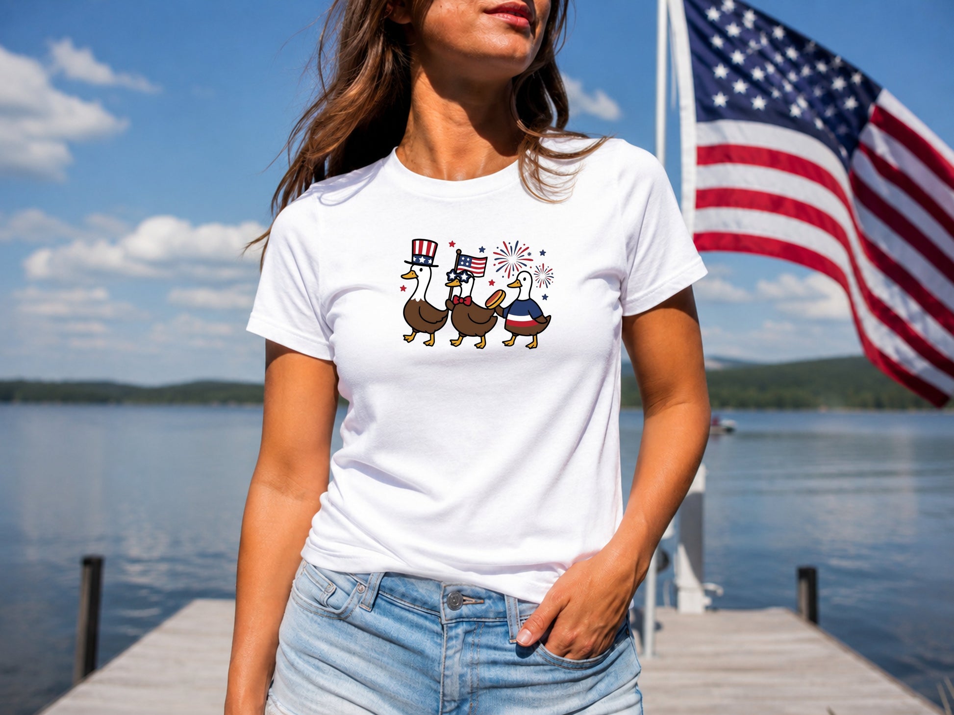 White t-shirt with three patriotic ducks wearing hats, holding flags.