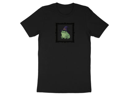 Black t-shirt with a framed cartoon frog wearing a witch hat.