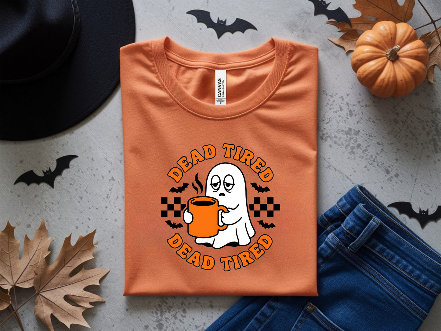 Orange t-shirt with a ghost holding a coffee cup and text "DEAD TIRED".