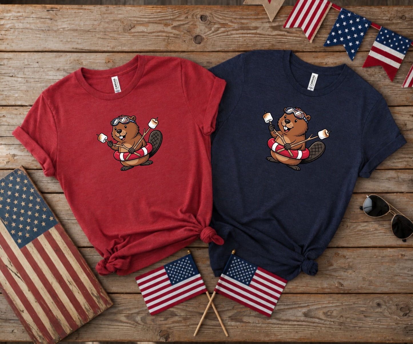 Red and navy t-shirts featuring a beaver wearing goggles and holding marshmallows.