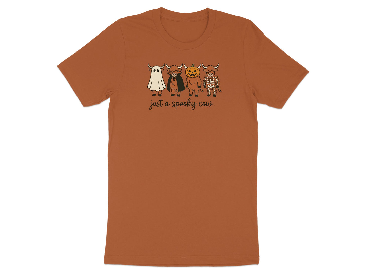 Brown t-shirt with white cartoon highland cows dressed as a ghost, vampire, pumpkin, and skeleton.