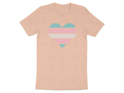 Peach t-shirt with a striped transgender pride heart graphic.