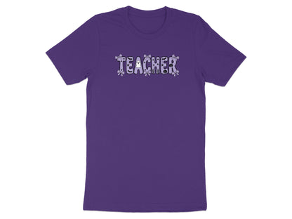 Purple t-shirt with "TEACHER" text featuring Halloween icons and bows.
