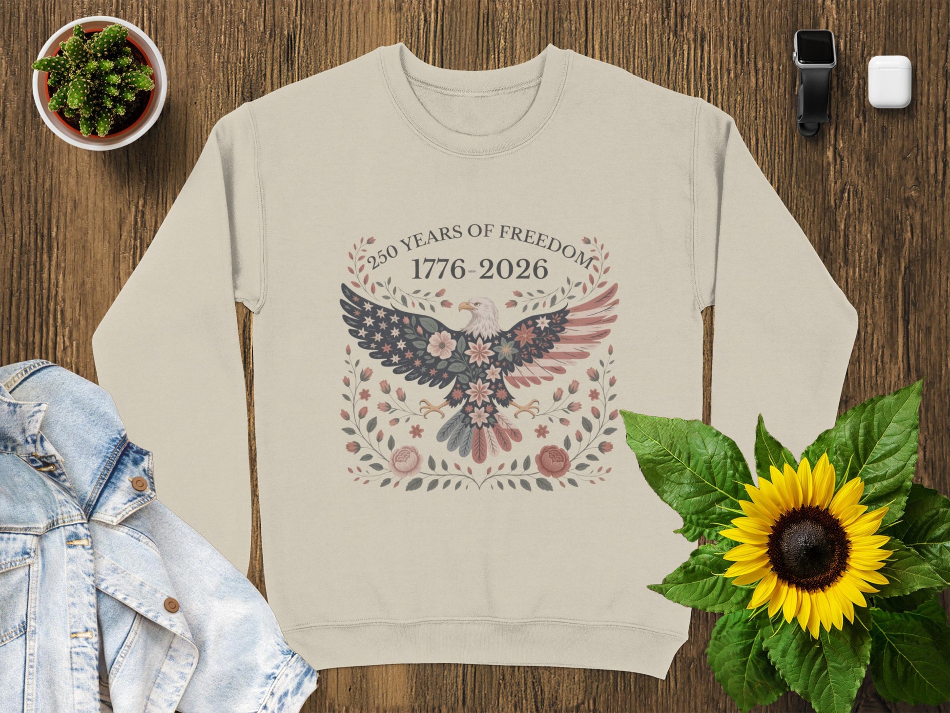 Cream sweatshirt with eagle and floral wreath, "250 Years of Freedom 1776-2026".