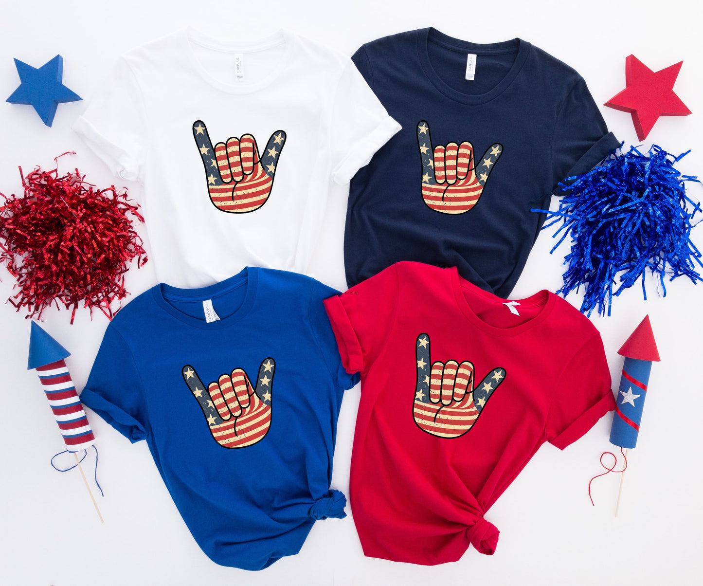 Four patriotic t-shirts featuring a hand sign with stars and stripes pattern.