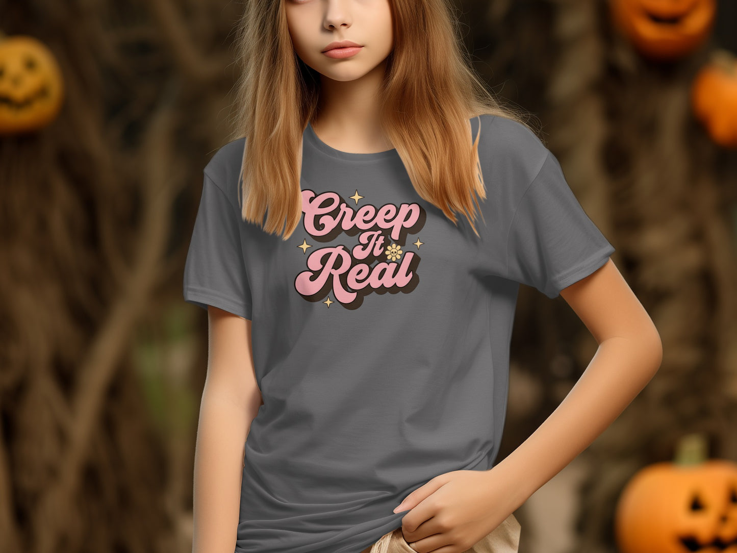 Girl wearing grey t-shirt with "Creep It Real" text and Halloween decorations