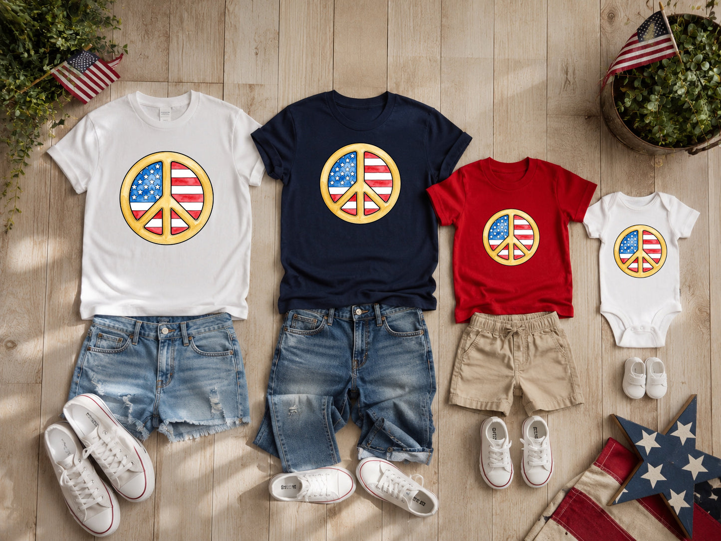 Adult and baby patriotic shirts and denim shorts arranged with American flags.