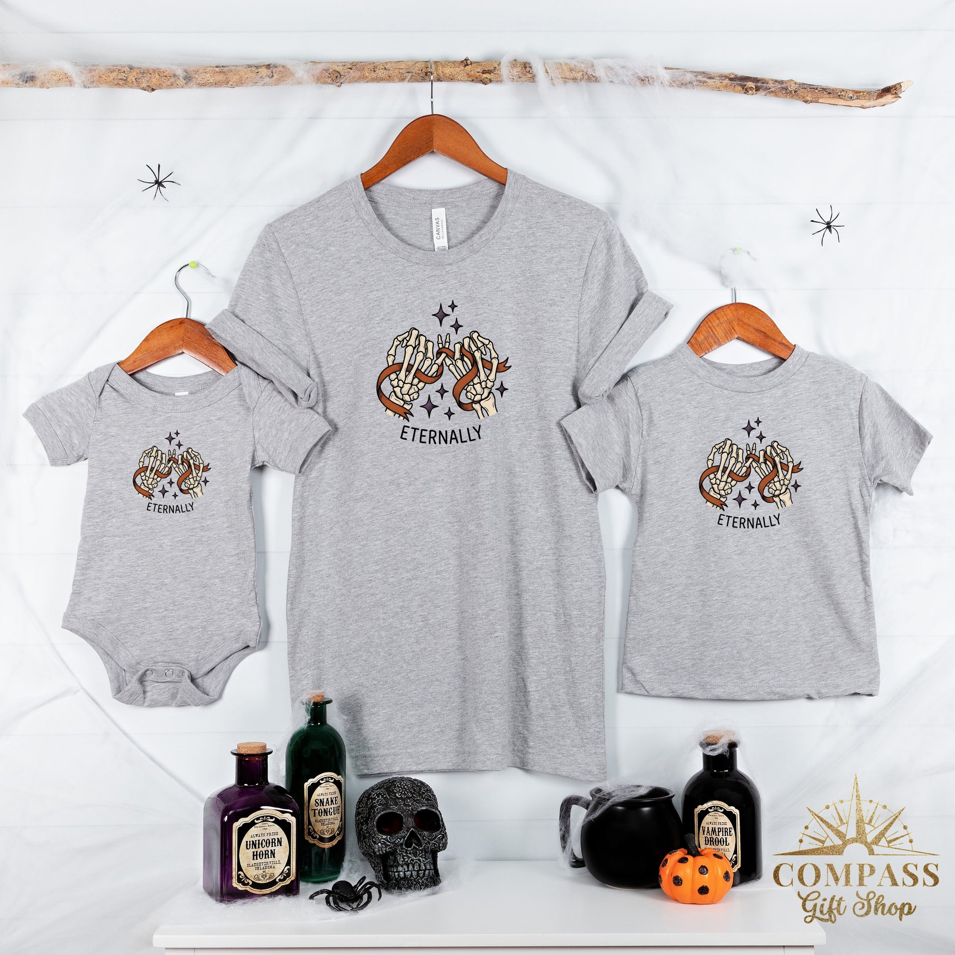 Three grey t-shirts with skeleton hand graphic and "Eternally" text.