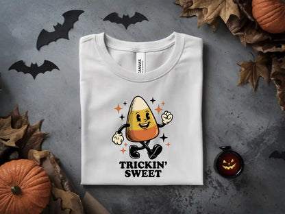 White t-shirt with a retro candy corn graphic saying "Trickin' Sweet".