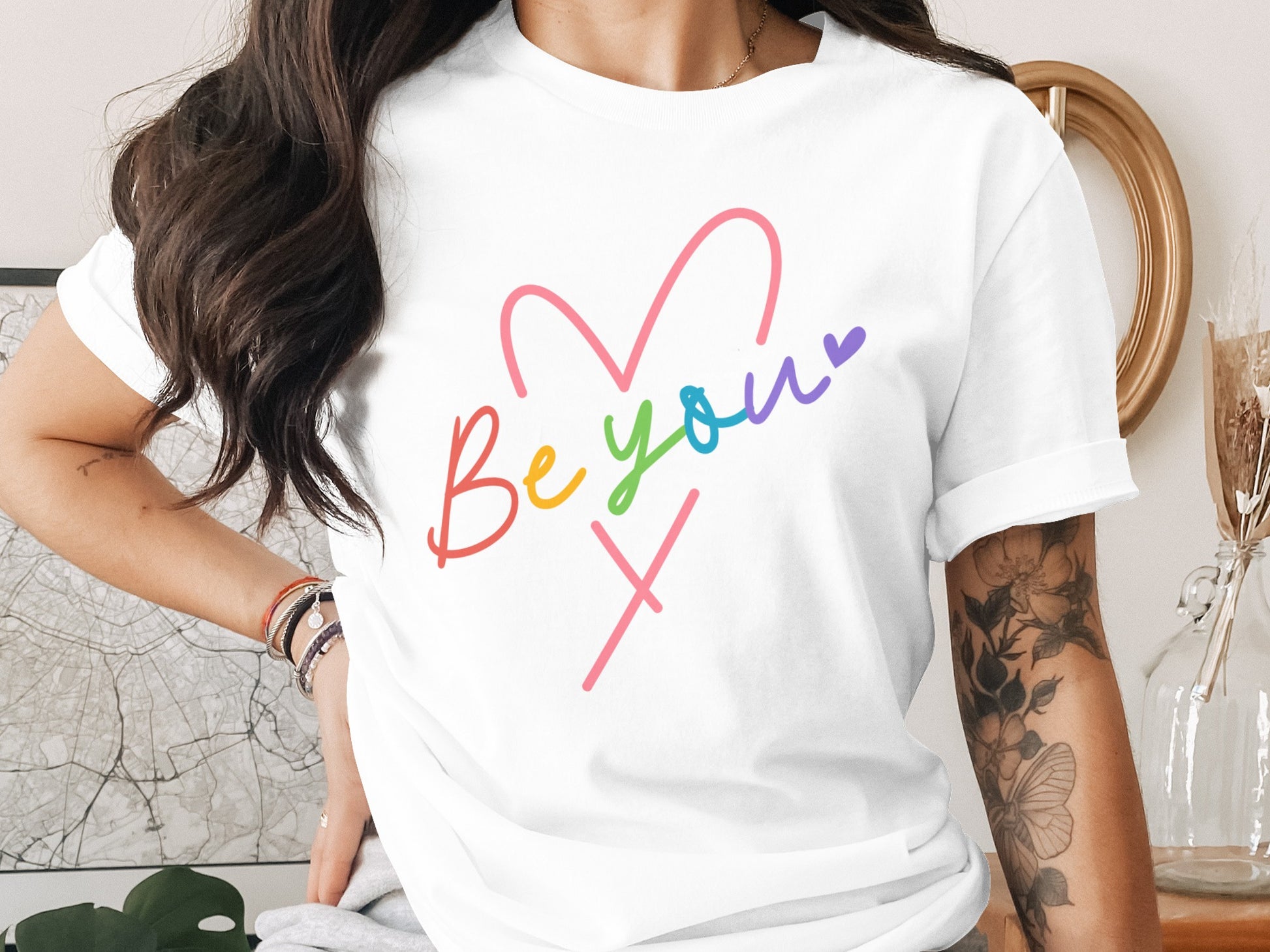 White t-shirt with "Be you" and a heart in colorful cursive.