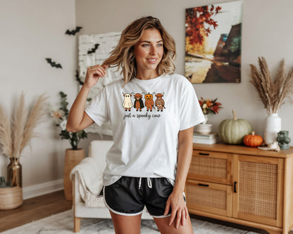 White t-shirt with Halloween cows graphic and text "just a spooky cow".