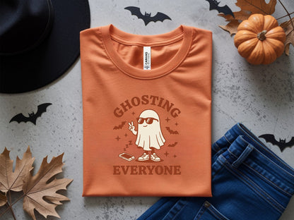 Orange t-shirt with ghost graphic and text "GHOSTING EVERYONE".