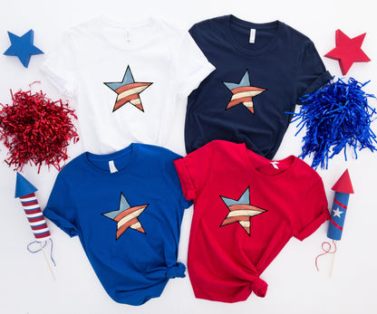 Four t-shirts in white, navy, royal blue, and red, each with a striped star design.