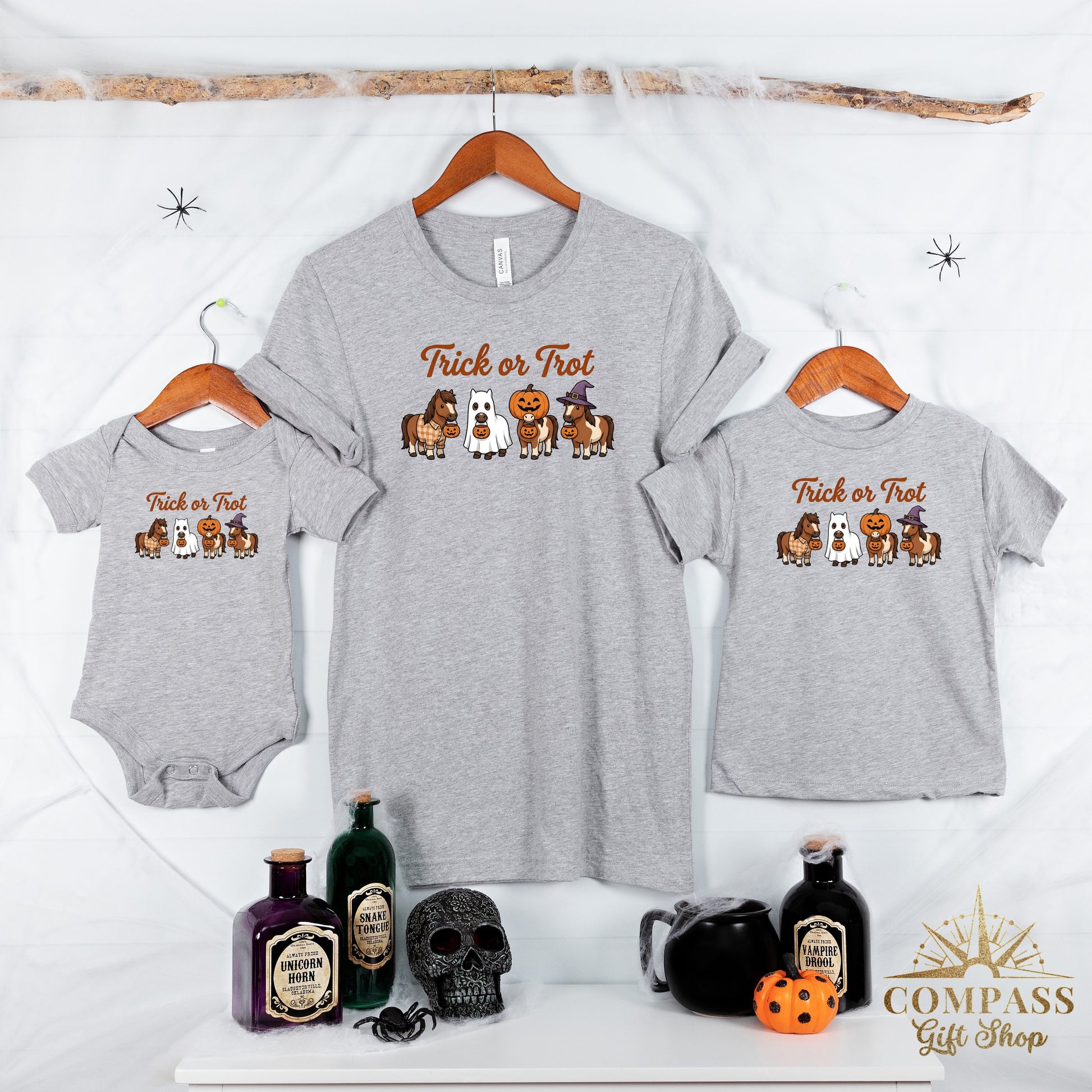 Grey t-shirts and baby onesie with horses in Halloween costumes and "Trick or Trot" text.