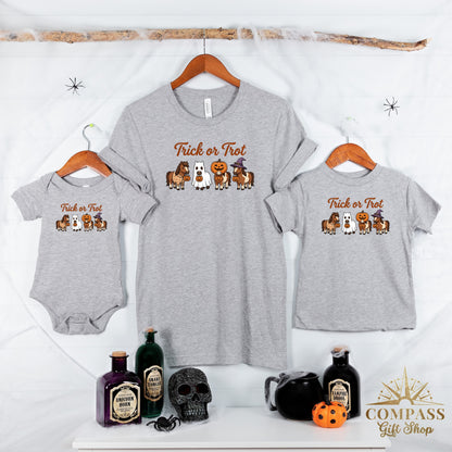 Grey t-shirts and baby onesie with horses in Halloween costumes and "Trick or Trot" text.