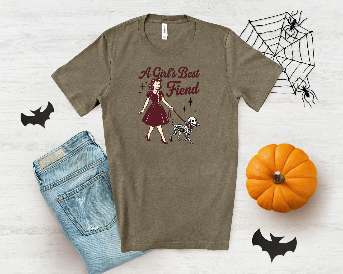 T-shirt with "A Girl's Best Fiend" text and retro woman walking skeleton dog illustration.