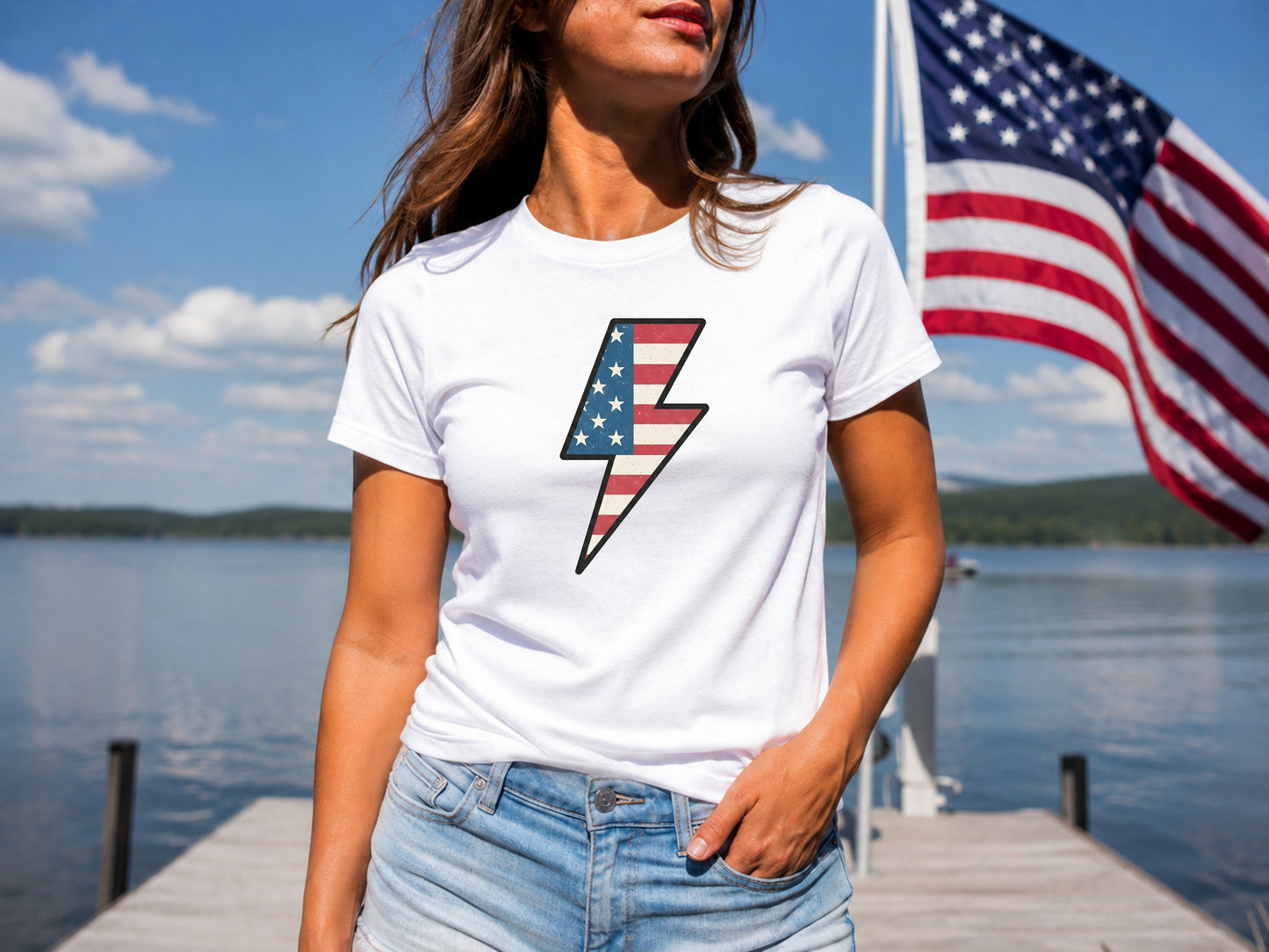 Woman wearing white t-shirt with American flag lightning bolt graphic.