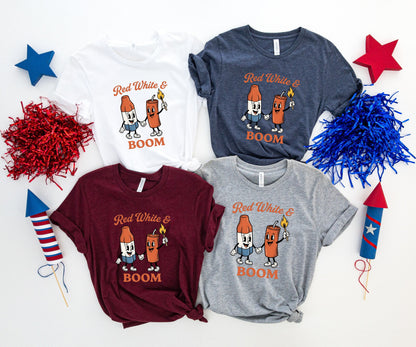 Four t-shirts with "Red White & BOOM" design and cartoon fireworks.
