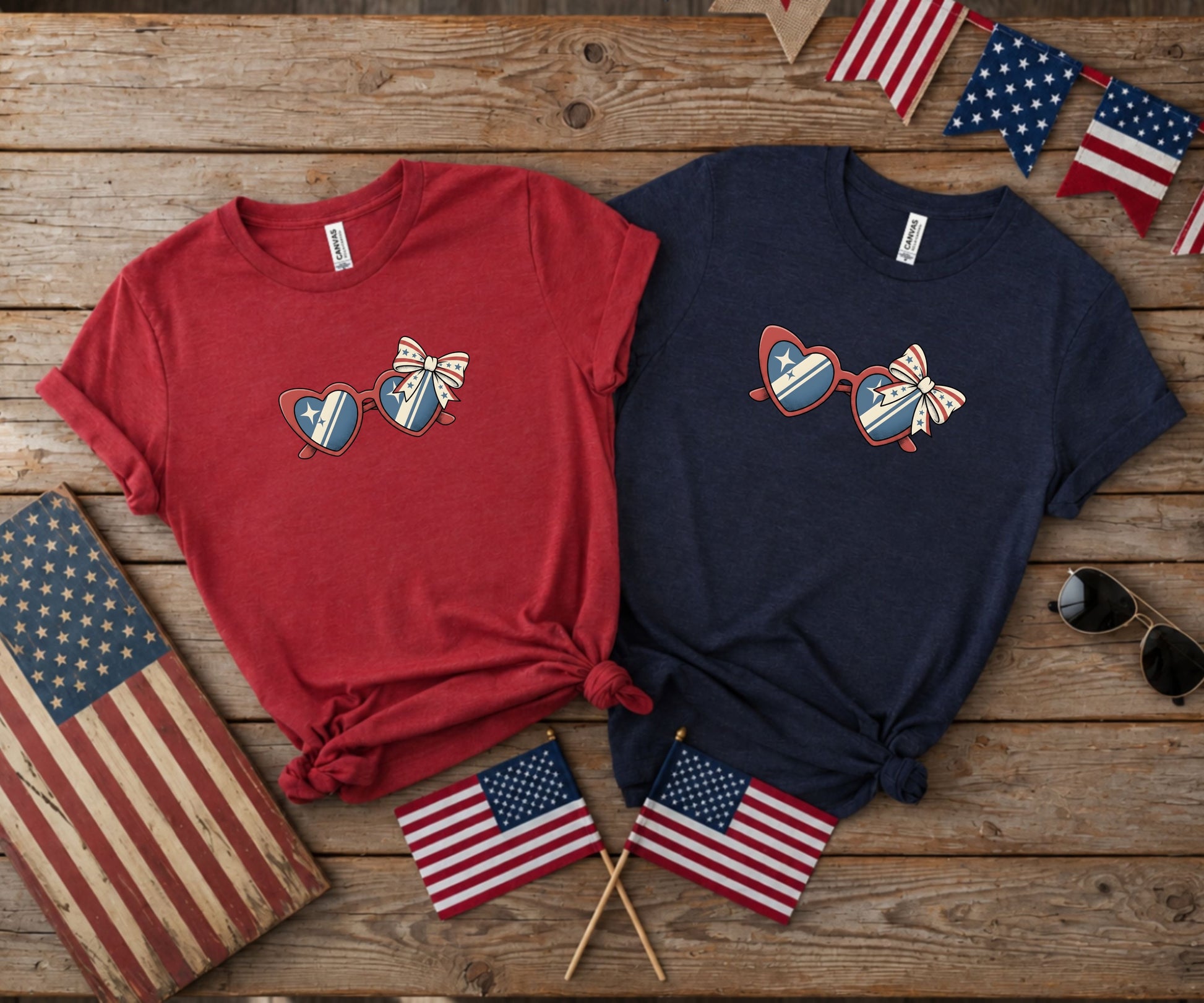 Red and navy t-shirts with heart-shaped sunglasses design, patriotic theme.