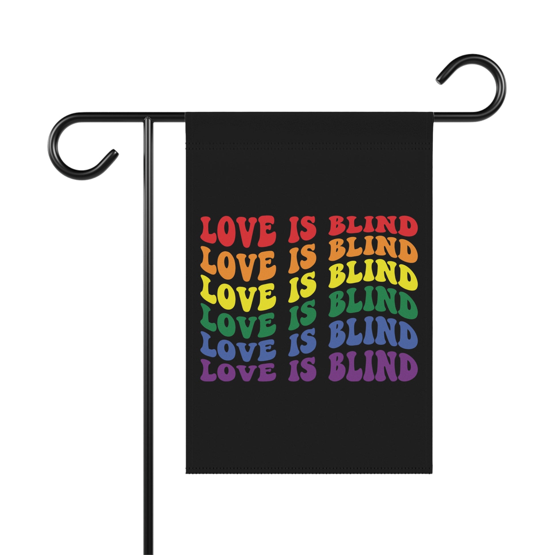 Black garden flag with "LOVE IS BLIND" repeated in rainbow colors.
