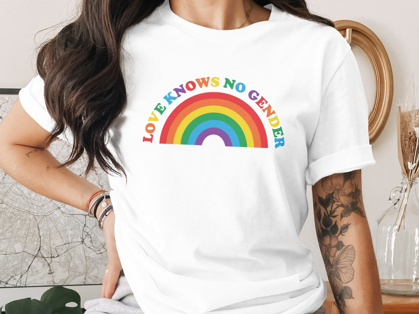 White t-shirt with rainbow text "LOVE KNOWS NO GENDER".