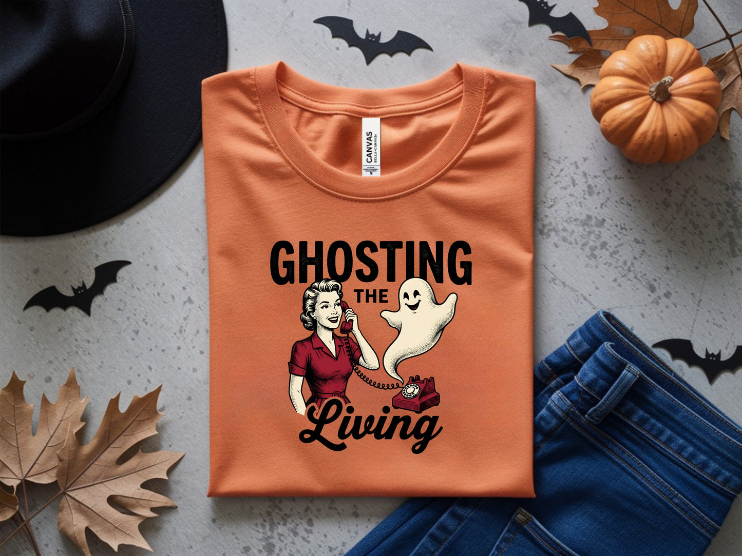 Orange t-shirt with "Ghosting the Living" graphic, a woman on a phone and a ghost.