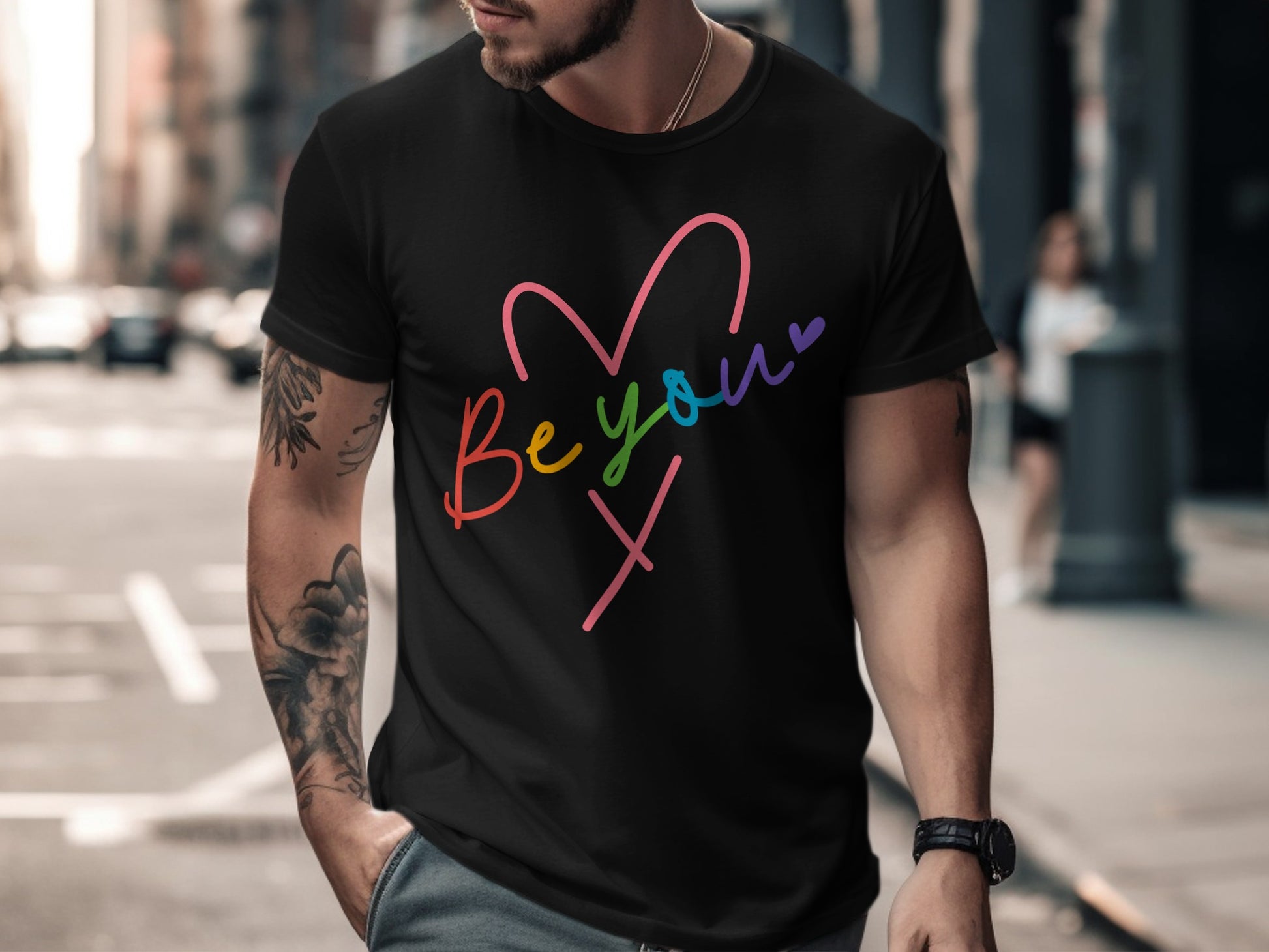 Black t-shirt with colorful "Be you" heart graphic and "X" symbol.
