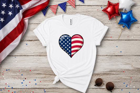 White t-shirt with a split USA flag heart design, adorned with confetti and balloons.