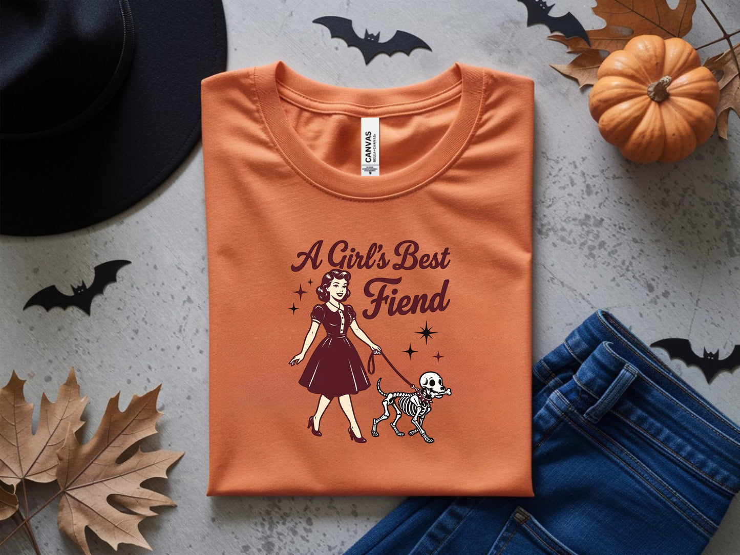 Orange t-shirt with "A Girl's Best Fiend" graphic and skeleton dog.