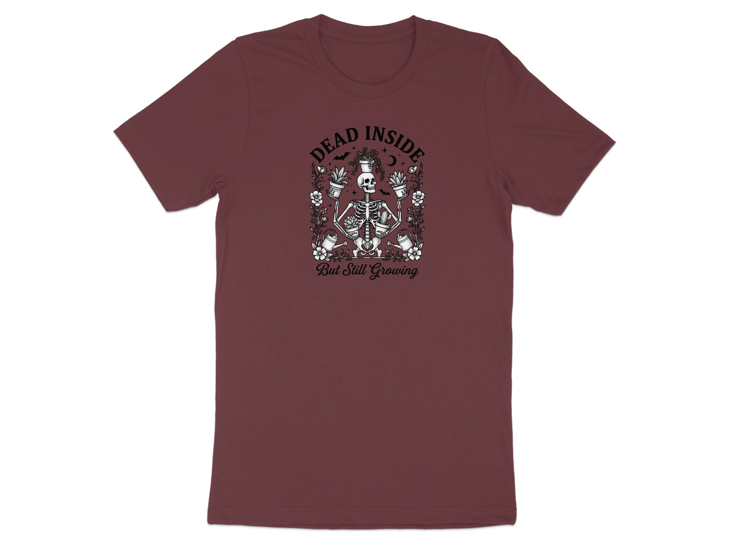 Burgundy t-shirt with a skeleton holding plants and the text "DEAD INSIDE But Still Growing."
