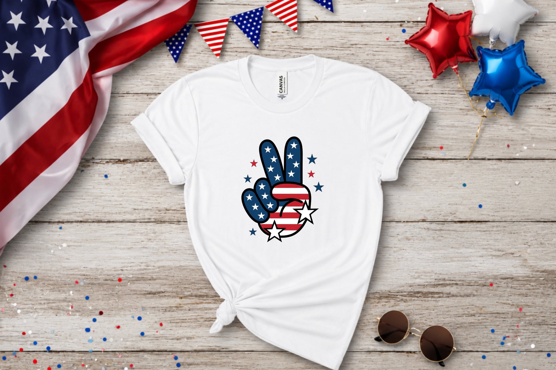 White t-shirt with American flag peace sign graphic, patriotic bunting and balloons.