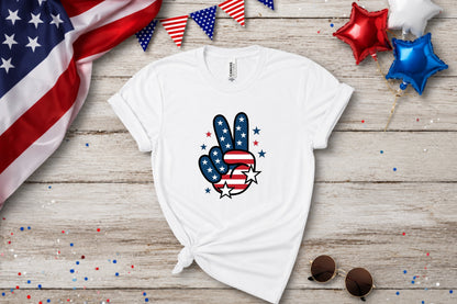 White t-shirt with American flag peace sign graphic, patriotic bunting and balloons.