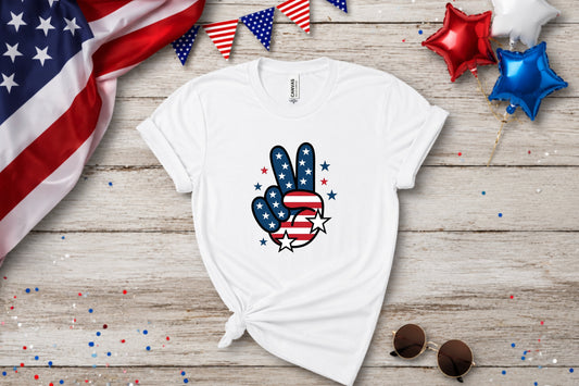 White t-shirt with American flag peace sign graphic, patriotic bunting and balloons.
