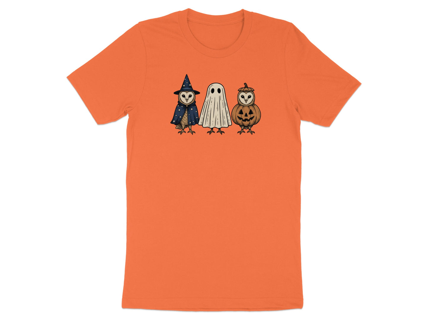 Three owls dressed as a witch, ghost, and jack-o'-lantern on an orange t-shirt.