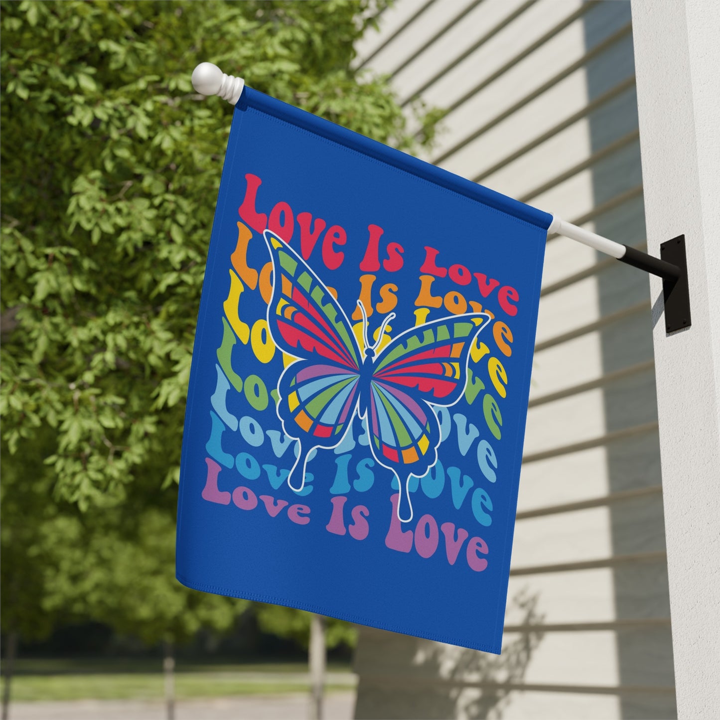 Blue flag with rainbow butterfly and "Love Is Love" text.